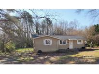 Charming single-story home featuring a welcoming front yard on a sunny day at 5628 Anderson Rd, Charlotte, NC 28269