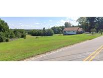 Charming single-story home with a spacious yard and covered porch, perfect for enjoying the outdoors at 6309 New Town Rd, Waxhaw, NC 28173