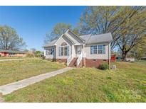 Charming one-story home featuring a welcoming front yard and traditional architectural details at 110 W Myers St, Monroe, NC 28110