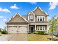 Charming two-story home featuring a welcoming front porch and a spacious three-car garage at 1430 Whitman Ct, York, SC 29745