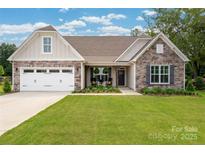 Charming single-Gathering home with stone accents, two-car garage, and well-maintained lawn at 2017 Autumn Dr, Monroe, NC 28110