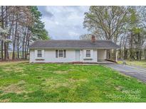 Charming ranch home with a well-maintained front lawn and convenient carport at 209 Vanderbilt Ave, China Grove, NC 28023
