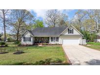 Charming single-Gathering home with a well-manicured lawn, a cozy front porch, and an attached garage at 2987 Irish St, Newton, NC 28658
