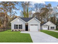 Charming single-story home with gray siding, a one-car garage, and a well-maintained lawn at 699 Jackson Sw Ter, Concord, NC 28027