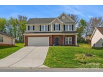 Charming two-story home with brick accents, well-maintained lawn, and a spacious two-car garage at 10107 Atkins Ridge Dr, Charlotte, NC 28213