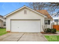 Attached one-car garage with white door and neutral vinyl siding at 1671 Sandpiper Dr, Rock Hill, SC 29732