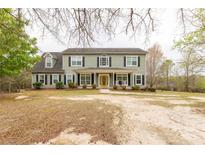 Charming two-story home featuring a welcoming front porch and a bright yellow front door at 1853 Beach Ln, Heath Springs, SC 29058