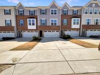 Charming townhouse exteriors with driveways and beautiful architectural details at 2557 Grantham Place Dr, Fort Mill, SC 29715