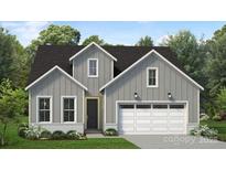Charming two-story home with a gray exterior, white trim, and a two-car garage at 4126 Eastover Glen Rd # 0317, Charlotte, NC 28269