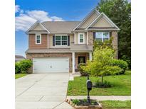 Charming two-story home featuring a brick facade, well-manicured lawn, and attached two-car garage at 4924 Riverdale Dr, Charlotte, NC 28273
