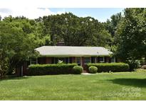 Charming brick ranch with manicured lawn and mature landscaping, perfect for outdoor enjoyment at 8608 Cedarbrook Dr, Charlotte, NC 28215