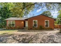 Charming brick home featuring large windows and a well-maintained front yard at 900 E Woodlawn Rd, Charlotte, NC 28209