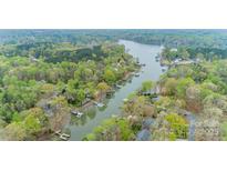 Stunning aerial view of lakefront homes surrounded by lush greenery and serene waters at 113 Hidden Ln, Mooresville, NC 28117