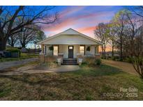 Charming single-story home with a welcoming front porch and freshly painted exterior and landscaping at 1545 7Th Avenue Sw Dr, Hickory, NC 28602