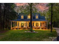 Charming home with a welcoming porch and three dormer windows nestled among trees, radiating a cozy and inviting ambiance at 2095 Westridge Dr, Rock Hill, SC 29732