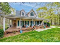 Inviting two-story home boasts a spacious porch with rocking chairs, perfect for enjoying the serene outdoor surroundings at 2095 Westridge Dr, Rock Hill, SC 29732