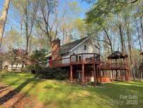 Charming home featuring a large deck, brick chimney, and a beautiful gazebo at 245 Clontz Hill Rd, Troutman, NC 28166