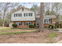 Charming two-story home with brick facade, green shutters, and a landscaped front yard at 4603 Oakwood Cir, Gastonia, NC 28056