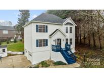 Charming two-story home with blue shutters and a matching blue staircase leading to the front door at 5680 Gold Creek Bay None, Hickory, NC 28601