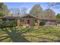 Charming stone-accented home with a red front door and well-manicured front yard at 118 Lakewood Dr, Kings Mountain, NC 28086