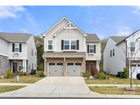 Charming two-story home with brick accents and a convenient two-car garage at 1268 Scotch Meadows Loop, Monroe, NC 28110