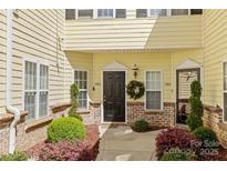 Welcoming entrance featuring a wreath, decorative shrubs, and a well-lit doorway at 1386 21St Ne Ave, Hickory, NC 28601