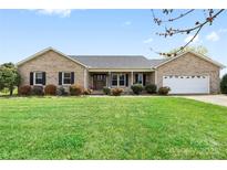 Charming brick ranch home with a well-maintained lawn and an attached two car garage at 139 Meadow Oaks Dr, Statesville, NC 28625