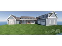 New construction of a beautiful two-story home with blue siding and a two-car garage on a lush green lawn at 2334 Bridgewater Rd # 6, Rock Hill, SC 29730