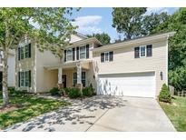 Beautiful two-story home with a welcoming front porch, black shutters, and a well-maintained lawn at 3009 Early Rise Ave, Indian Trail, NC 28079