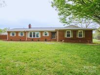 Charming brick home with a well-manicured lawn and beautiful landscaping at 3452 Flat Creek Rd, Lancaster, SC 29720