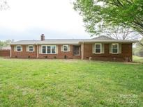 Charming brick ranch home featuring a well-maintained lawn and established landscaping at 3452 Flat Creek Rd, Lancaster, SC 29720