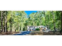 Charming single-story home nestled in a serene wooded setting at 368 Northwood Dr, Troy, NC 27371