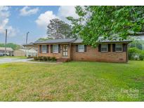 Charming single-story brick home featuring shuttered windows and a well-maintained lawn at 417 Donna Ave, Gastonia, NC 28052