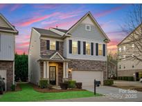 Charming two-story home featuring a stone facade, well-manicured lawn, and an attached two-car garage at 6020 Union Pacific Ave, Charlotte, NC 28210