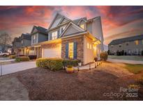 Charming townhome with stone accents, attached garage, and manicured landscaping at 6619 Portland Rose Ln, Charlotte, NC 28210
