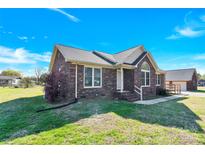 Charming brick home featuring a well-manicured lawn and traditional architectural details at 115 Green Sw St, Concord, NC 28027