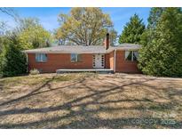 Charming brick home with well-maintained landscaping and inviting front porch at 237 Palaside Ne Dr, Concord, NC 28025