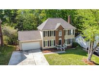 Charming two-story home with brick and siding, complemented by a well-manicured lawn at 2512 Pimpernel Rd, Charlotte, NC 28213