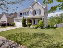 Charming two-story home boasts a well-manicured lawn and inviting curb appeal at 848 Wingthorn Rose Dr, Gastonia, NC 28056