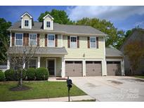 Charming two-story home with a three car garage and manicured lawn at 12517 Pine Terrace Ct, Charlotte, NC 28273