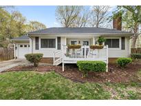 Charming single-story home featuring a welcoming front porch with flower boxes and a well-maintained yard at 1555 Ridgewood Dr, Gastonia, NC 28054