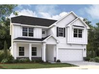 Charming two-story white home with a covered porch and attached two-car garage at 2014 Puddle Pond Rd, Indian Trail, NC 28079