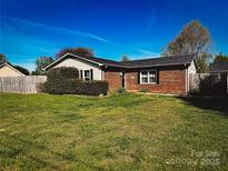 Charming brick home featuring a well-manicured lawn and mature landscaping at 2906 Montford Nw Ave, Concord, NC 28027