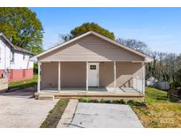 Charming home featuring neutral siding, a cozy front porch, and a well-manicured lawn at 416 E Park Ave, Gastonia, NC 28054