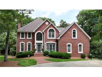 Charming red brick home with manicured lawn and mature landscaping on a sunny day at 101 Saddletree Rd, Lincolnton, NC 28092