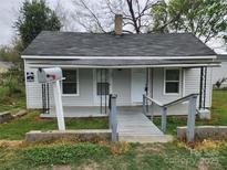 Modest single story home featuring a small front porch, gray siding, and a quaint mailbox at 109 Starnes St, Chester, SC 29706