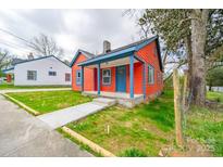 Charming single-Gathering home boasting a vibrant color scheme and inviting front porch at 121 Oak St, Chester, SC 29706