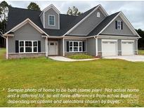 Charming two-story home with gray siding, black shutters, white trim, and an attached two-car garage at 135 Falls Leaf Dr # 14, Troutman, NC 28166