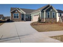 Charming home with stone accents, a paved driveway, and a welcoming two-car garage at 1933 Hendricks St, Rock Hill, SC 29732