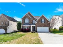 Charming two-story brick home with a two-car garage and well-maintained landscaping at 2275 Laurens Dr, Concord, NC 28027